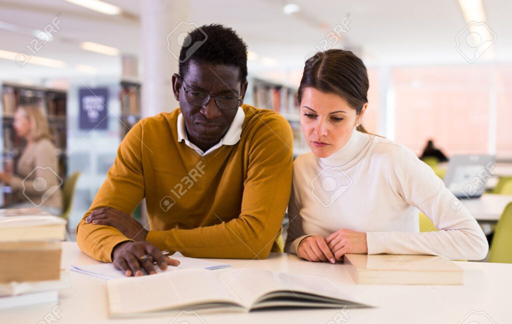 197208547 personas leyendo y tomando notas mientras se preparan para el examen en la biblioteca