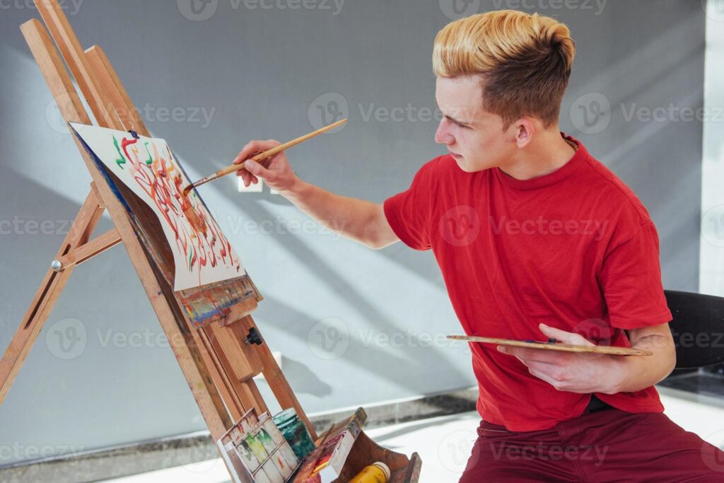 artist painting a picture in a studio photo